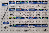 RC helicopter parts lot with packaged components on pegboard display