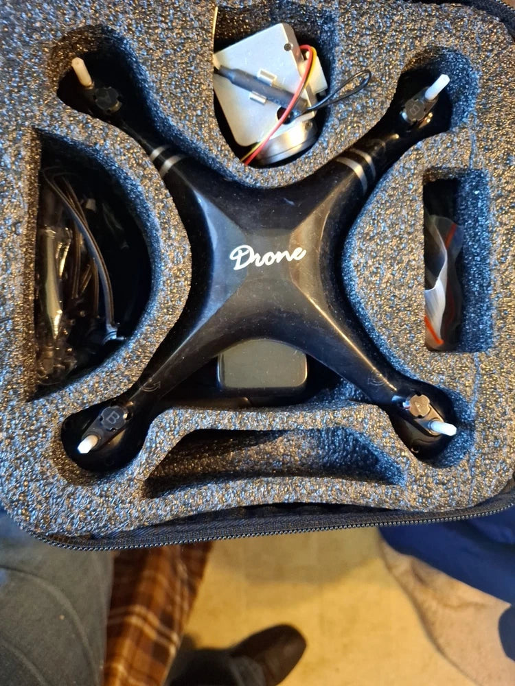 RC quadcopter drone with four black prop arms and 'Dane' marking on body