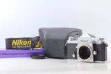 Nikon F 35mm film camera with lens opening, silver body, and gray carrying case