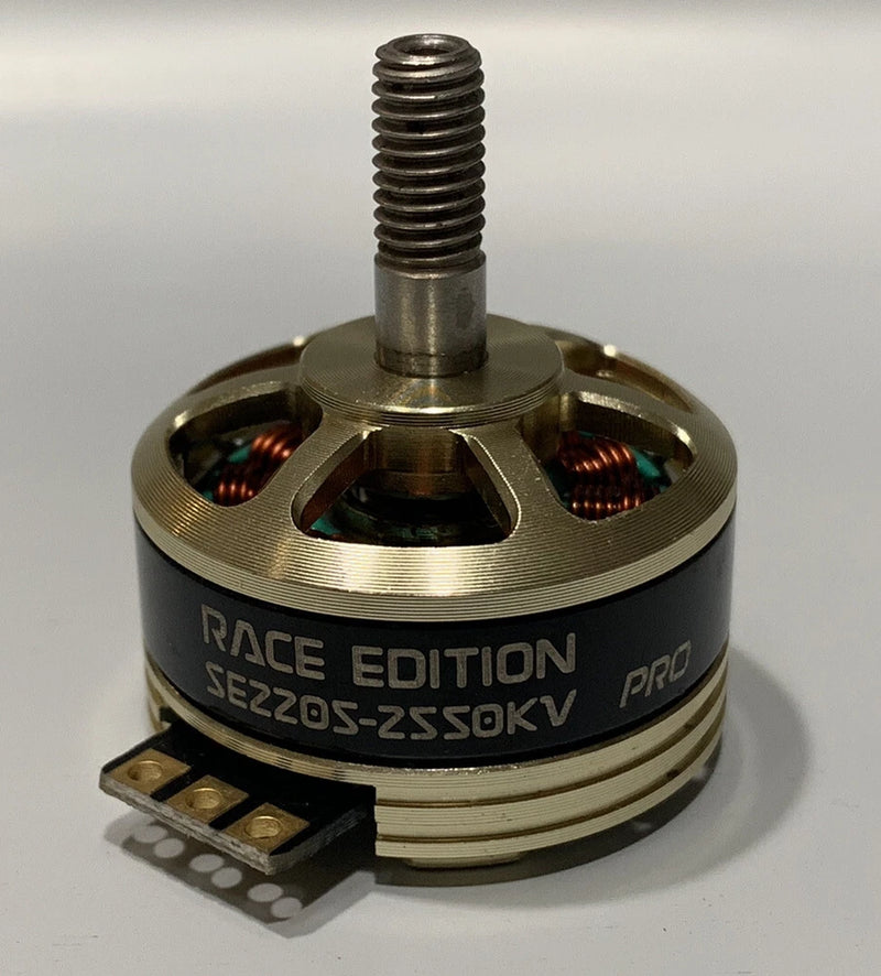 FPV hollow-shaft race motor with bronze can, wiring pads, and RACE EDITION text