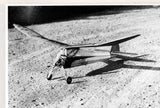 Black and white high-wing RC airplane model with long fuselage and propeller