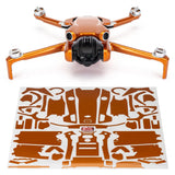 WRAPGRADE drone with orange arms and front camera, with orange decal wrap sheet