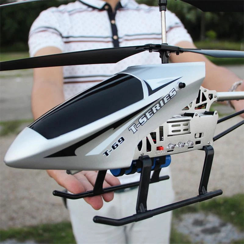 RC helicopter drone with white and black fuselage, landing skids and rotor mast