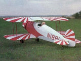 Red and white RC biplane model with fabric-style wings and cockpit window