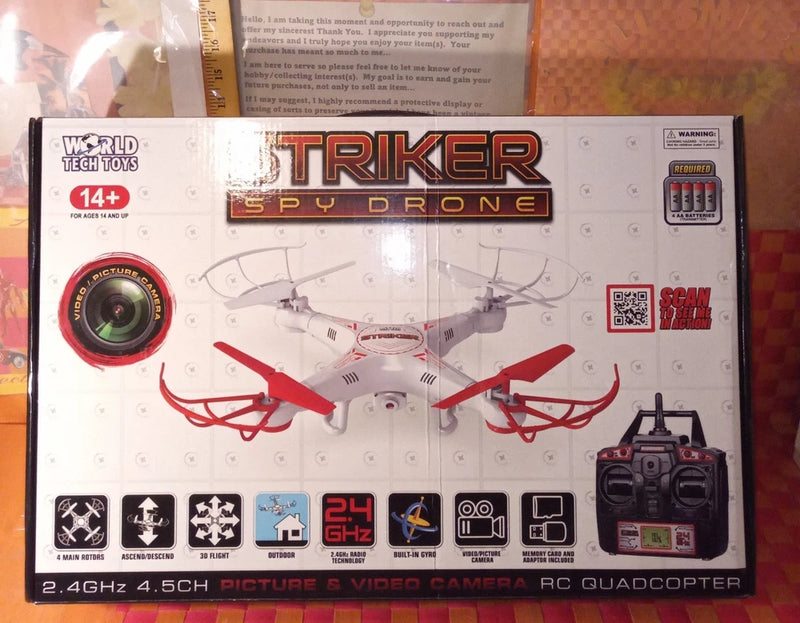 RC spy drone box with quadcopter illustration, red propellers, and camera window