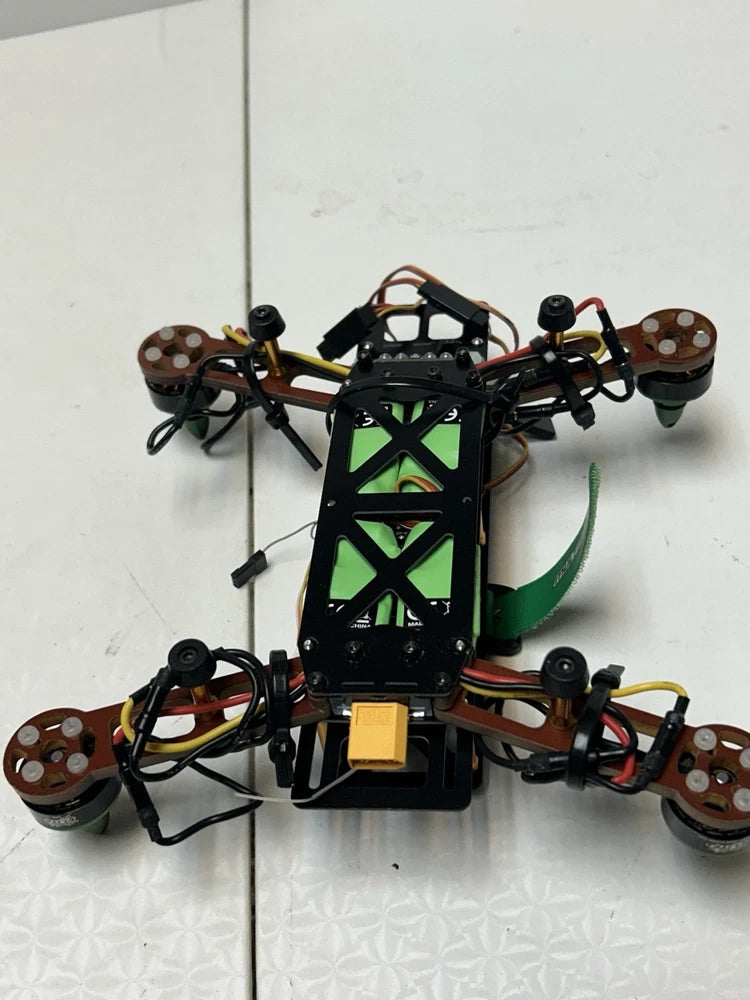 Quadcopter drone with green LED lights, four propellers, and landing frame