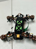 Quadcopter drone with green LED lights, four propellers, and landing frame