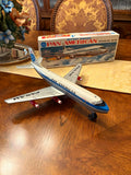 Battery-powered Pan American DC-8 model airplane, blue with propellers, on display