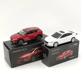 Die-cast car model set with red and white vehicles, shown in their display boxes