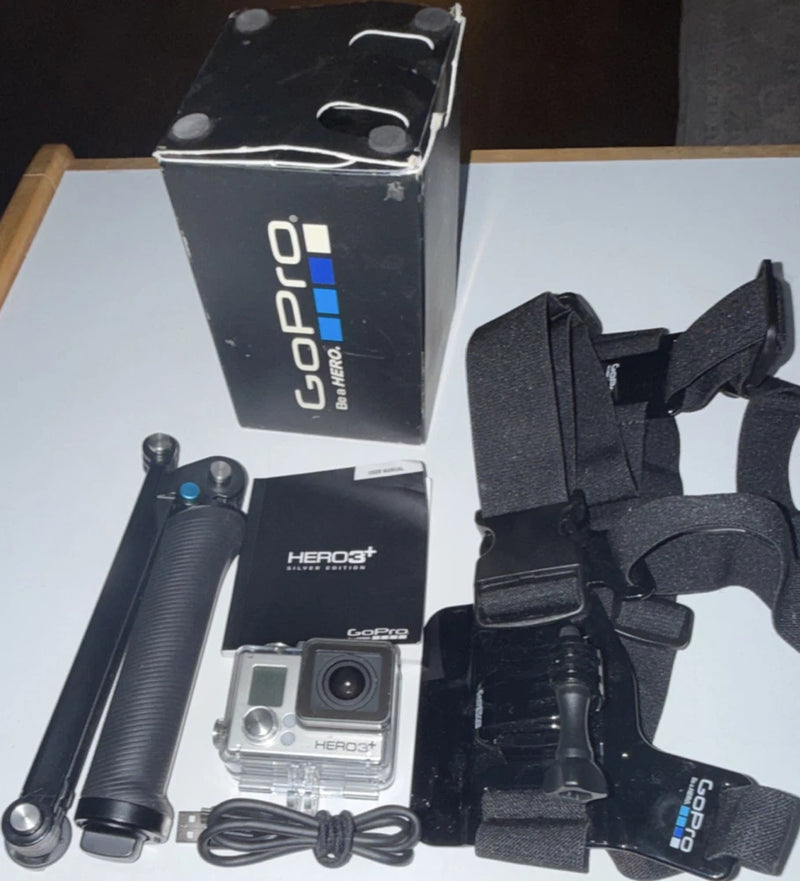 GoPro HERO3+ silver action camera kit with mount straps, handle, and USB cable