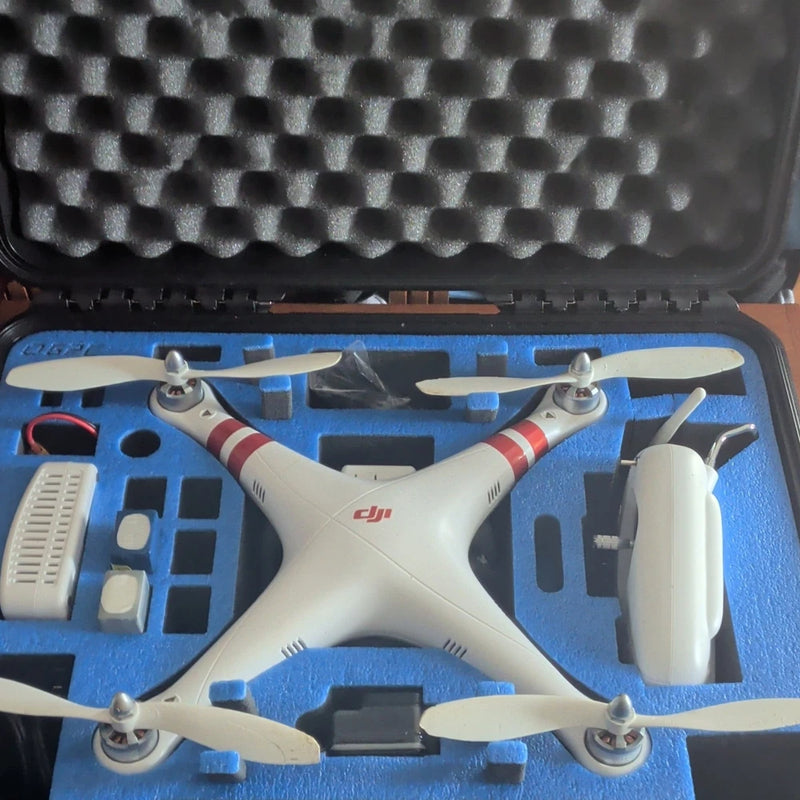 DJI quadcopter drone with white body and four propellers inside blue case