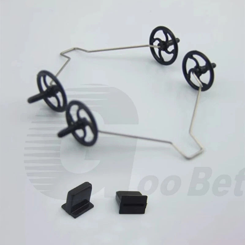 RC aircraft landing gear wheel kit with four black wheels and two black mounting blocks