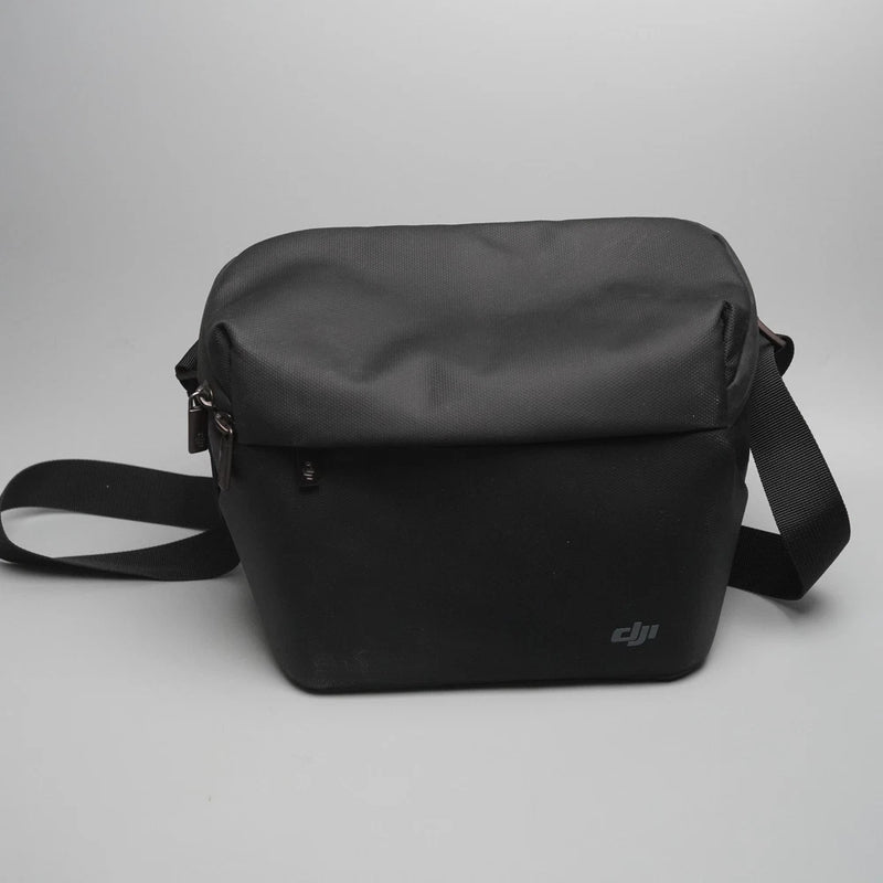 Black DJI shoulder bag with adjustable strap and zip top, for drone accessories