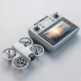 Gray RC quadcopter drone with camera, paired with handheld remote controller