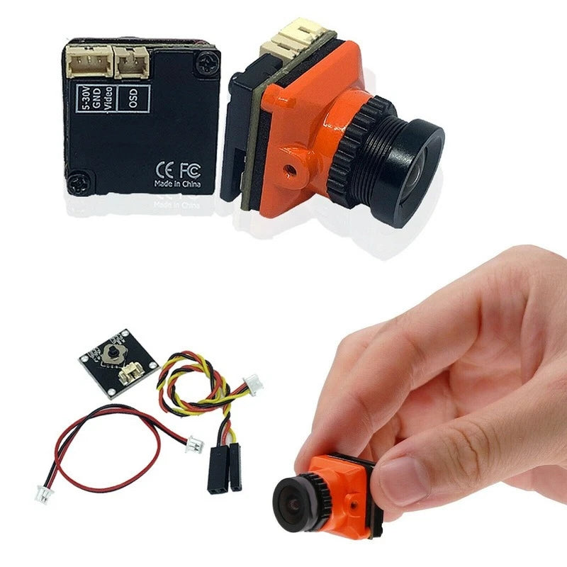 FPV drone camera module with orange housing and black lens, plus wiring and board.