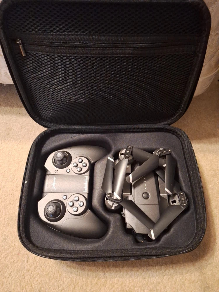 Camera drone with controller and accessories in open hard carrying case