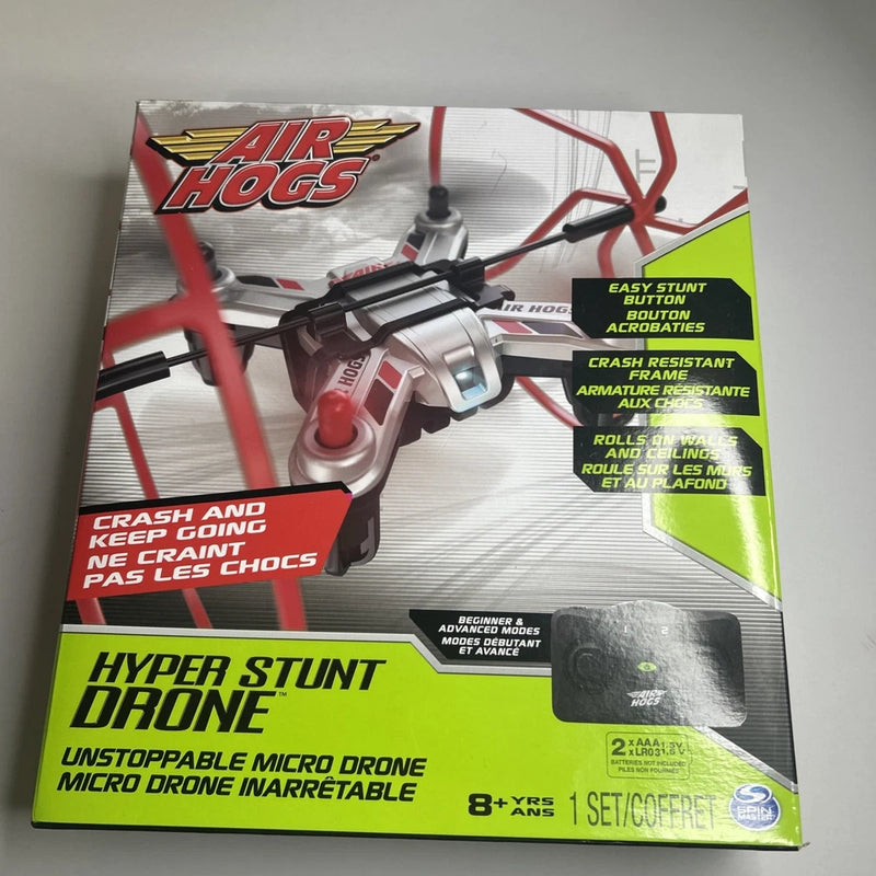 Micro RC stunt drone in retail box, red and white with “Air Hogs” logo