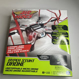 Micro RC stunt drone in retail box, red and white with “Air Hogs” logo