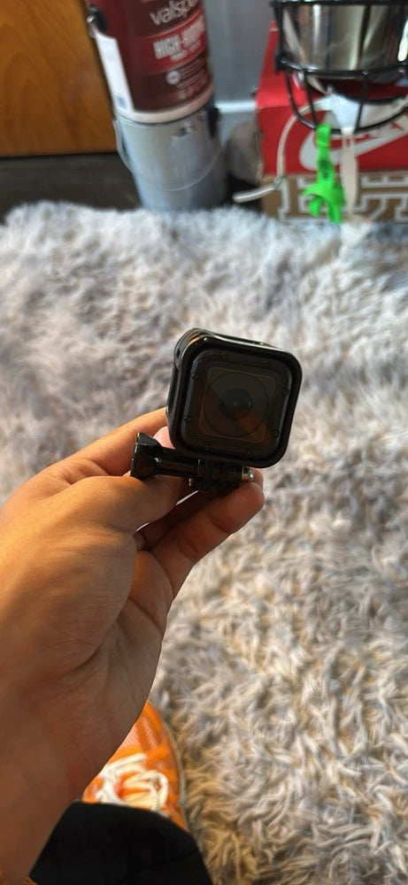 GoPro Hero Session 4 action camera in protective housing, held in hand