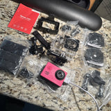 Pink HD sports action camera with waterproof housing and mounting accessories