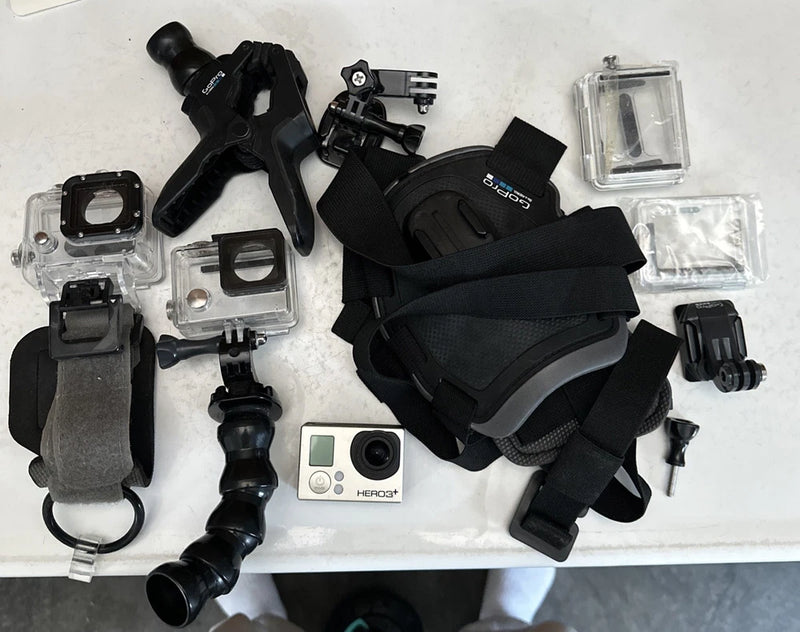 GoPro HERO3 Plus action camera with waterproof case, mounts, straps, and spare housing
