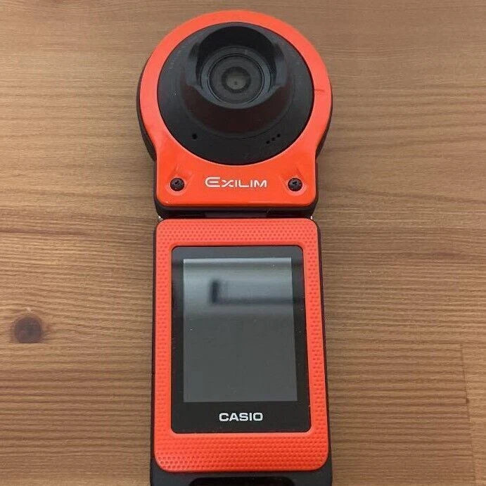 Orange CASIO action camera with front lens and rear LCD screen