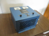 Blue metal battery charger box with front ventilation grille and control panel buttons