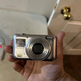 Compact Fujifilm FinePix JZ300 digital camera front with lens and buttons