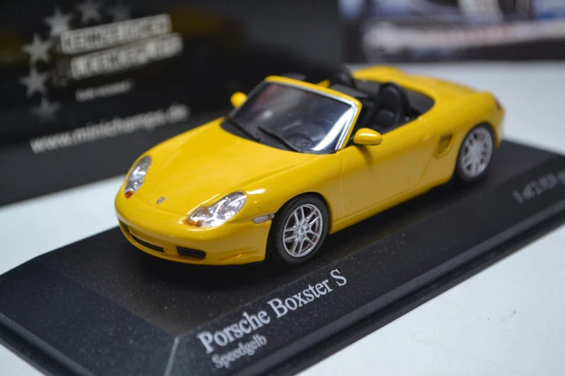 Yellow Porsche Boxster S 1:43 scale model car with silver wheels on display base