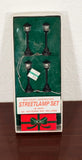 Battery-operated model train streetlamp set box with four black village lamps