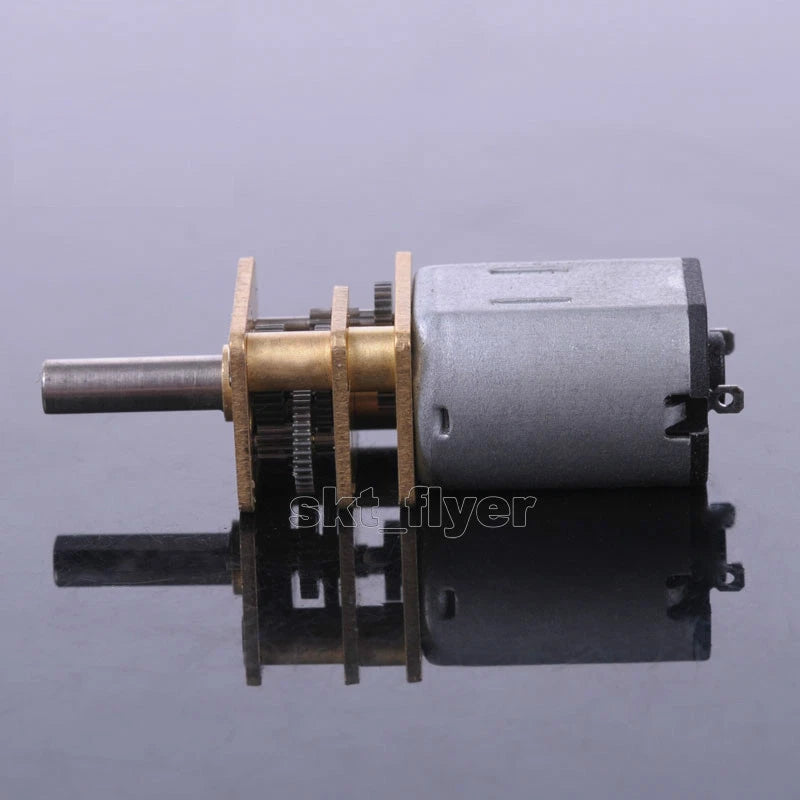 Metal DC gear motor with pinion gearwheel and protruding drive shaft, silver housing