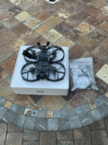 GepRC FPV drone with propellers in retail box, black frame