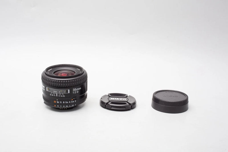 Nikon AF Nikkor 35mm f/2D wide-angle lens with front and rear caps