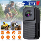 Black action camera with front lens and mounting clip, front view