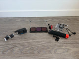 Action camera accessory bundle with protective housing, mounts, and red battery grip