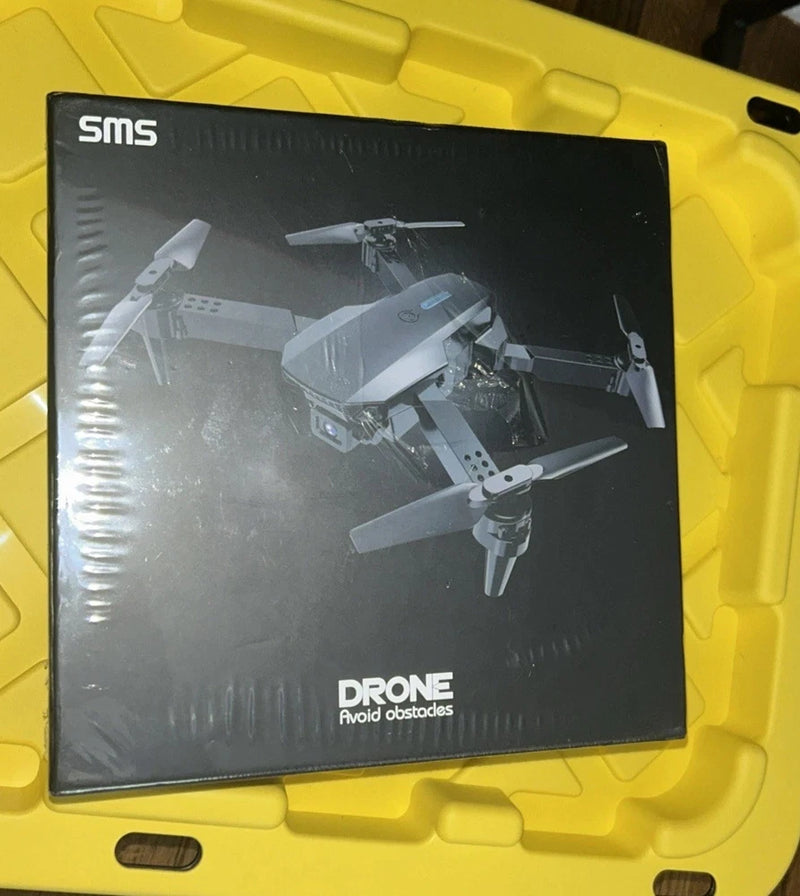 SMS drone 4K camera box with printed drone images and “Avoid obstacles” text