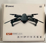 Pocket drone quadcopter with 4 black propellers, camera, and E58 label