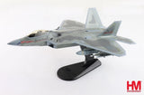 Gray stealth jet model with red markings on a black display stand
