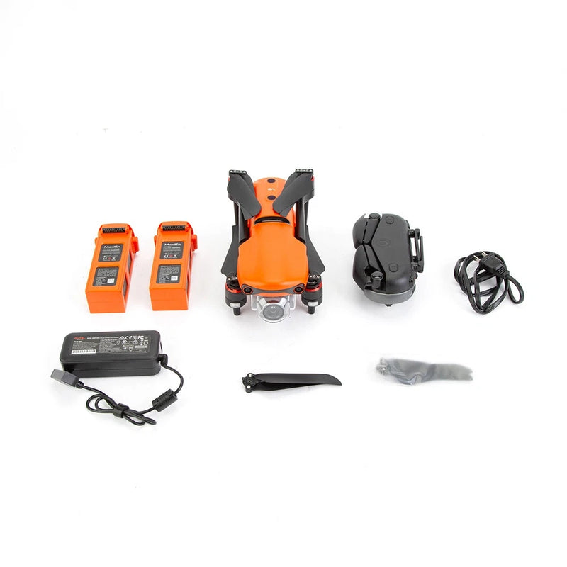 Rugged drone bundle with orange drone, remote, two batteries, charger, cables