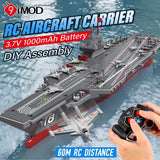 RC aircraft carrier model with remote control, gray deck and red hull, detailed masts