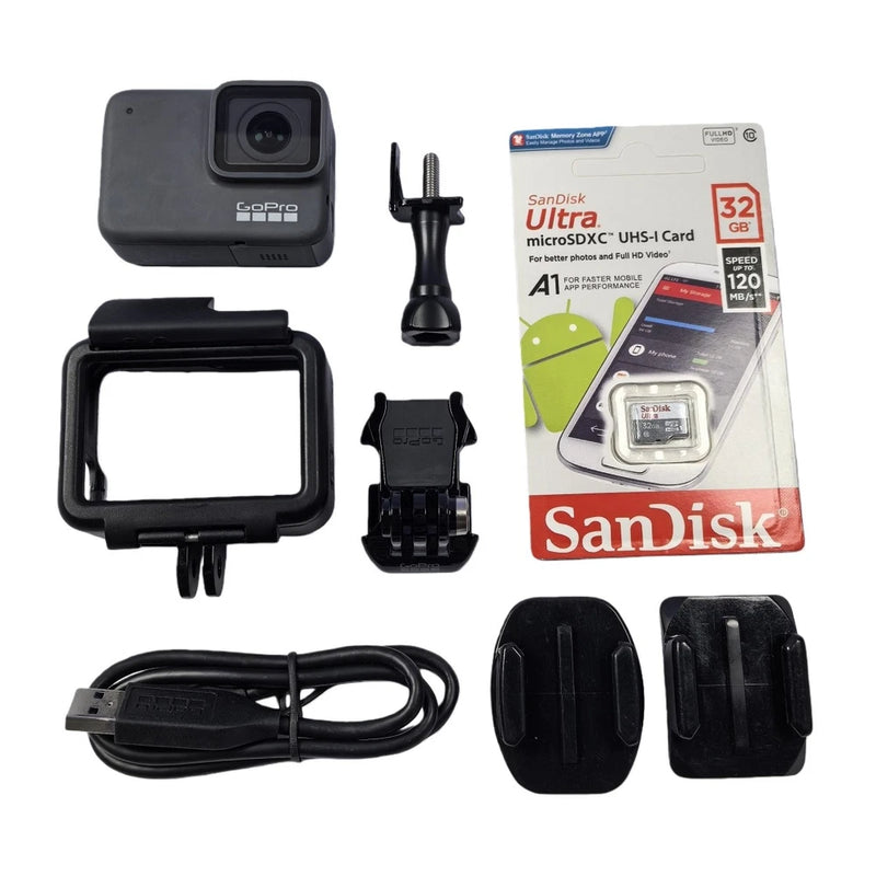 Silver GoPro action camera kit with waterproof housing, mounts, cable, and microSD card