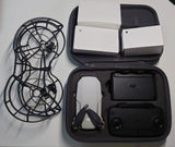 Drone with propeller guards, remote controller, and accessories in zippered case