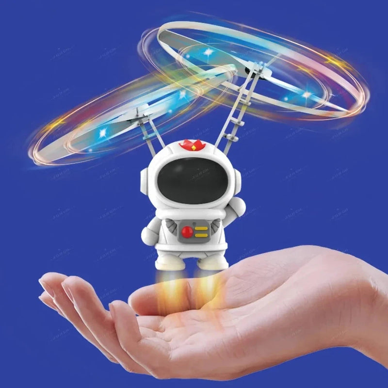 Luminous astronaut flying robot toy with glowing ring wings, held above hand