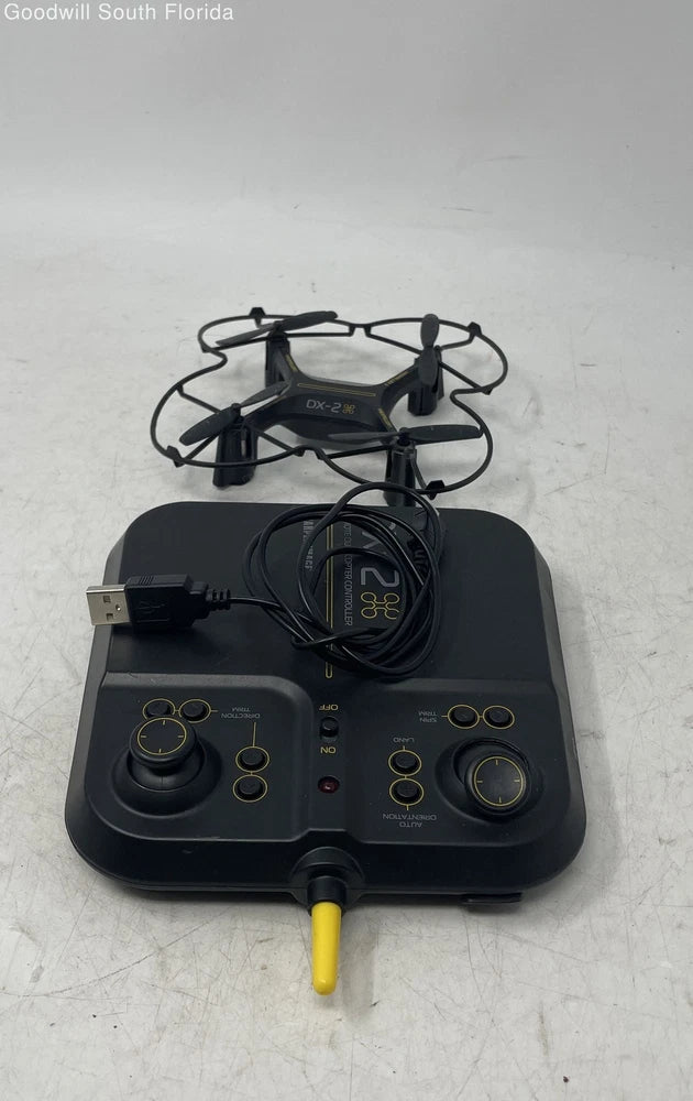 Black quadcopter drone with controller and attached cables, handheld remote-like base