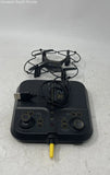 Black quadcopter drone with controller and attached cables, handheld remote-like base