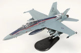 Gray F/A-18D Hornet model aircraft on display stand, with USMC markings