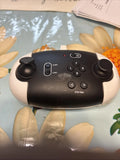 Black drone remote controller with dual joysticks, buttons, and power switch