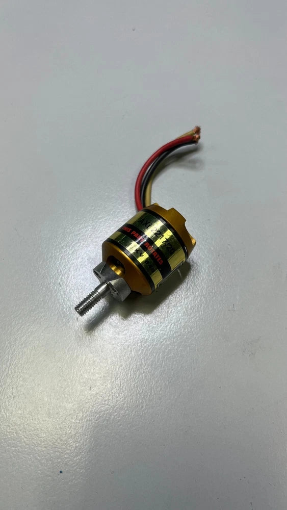 Gold cylindrical electric motor with wire leads and front metal shaft