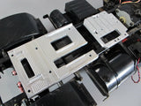 Aluminum servo mount plate with attached black servo motor and wiring