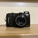 Fujifilm black compact digital camera with visible zoom lens and EXR branding